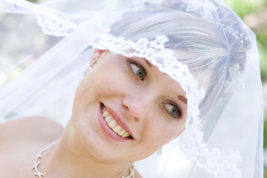 beautiful bride plays with her veil