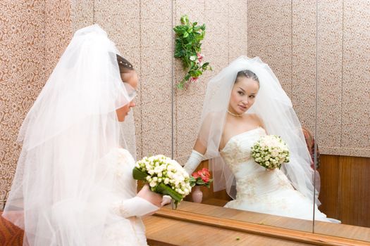 beautiful bride by a big mirror