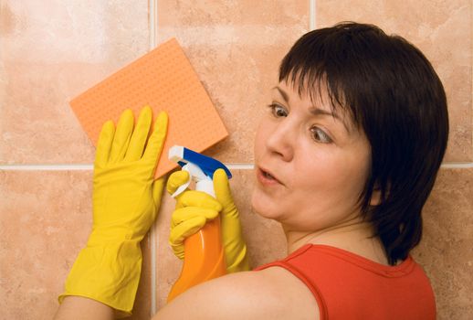 The tired housewife cleans a tile. Emotions