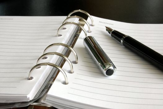 business organizer, notebook or planner with pen