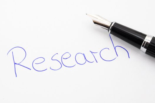 research concept with handwriting pen and paper