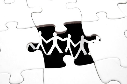puzzle and paper man team showing teamwork concept