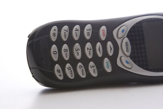black cell phone lying on it's side, with a close up on the keypad