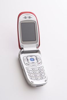 Red and silver cellular phone open with a blank screen