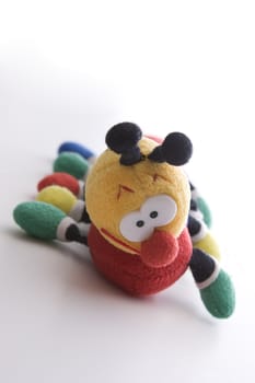 Close up view of a plush catapillar with big eyes