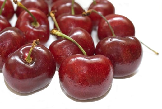 Several cherries isolated over a white background.