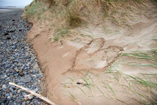 a love heart written in the sand on the west coast of ireland near ballybunion