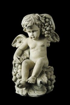 Cherub with dramatic side lighting on a black background.