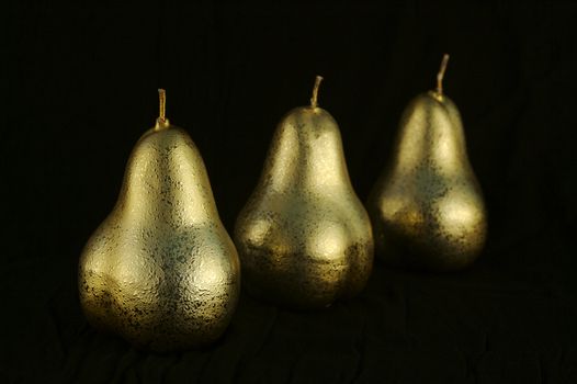 Golden Pears in a row with textured surface.