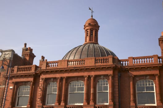 A victorian building witha dome on the roof