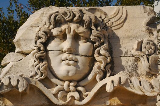Close-up of an ancient sculpture of Medusa.