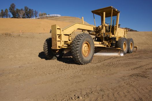 Tractor at a Cunstruction Site and dirt lot.