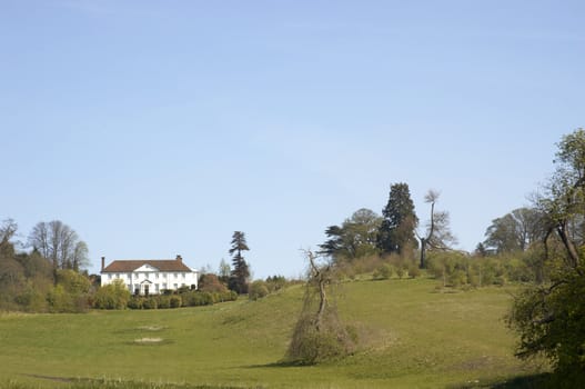 A view of a large house on top of a hill