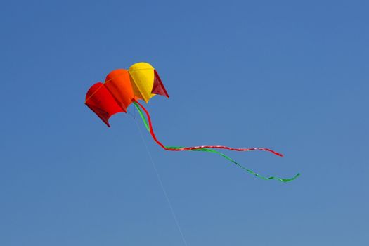 Flying kite on the blue sky