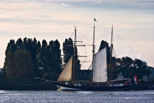 Sailingship "Oosterschelde" passing by on the river Maas on the way to her home port Rotterdam, the Netherlands