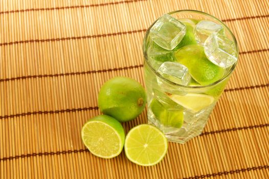 Caipirinha party cocktail with lemon and ice cubes