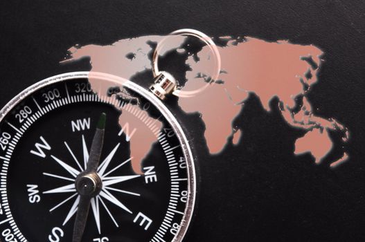 compass and world map showing travel or adventure concept