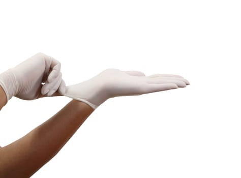 Woman's hands putting on surgical gloves-isolation over white background