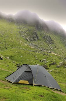 Tent in a mountaneos area during a cloudy moment.Location:Fagaras mountains,Romania.