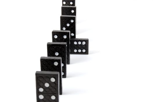 row of dominoes including a special domino stone isolated on white background