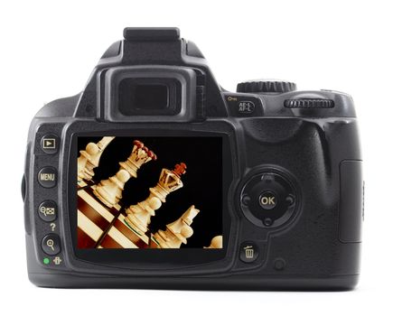digital camera and chess pieces isolated on white background