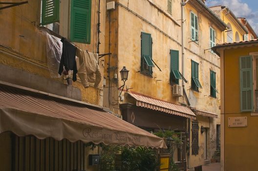 Quaint Narrow Street with Restaurants in France.