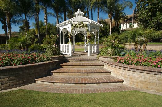 Elegant Wedding Gazebo with Steps and Lush Grass.