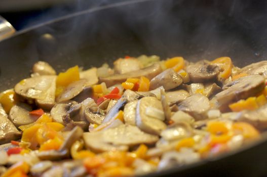 Mushroom and Vegetable Sauté with Steam and narrow depth of field.