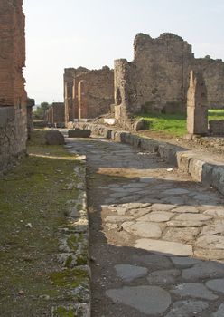 Cobblestone street and ancient ruins of Pompeii, Italy.