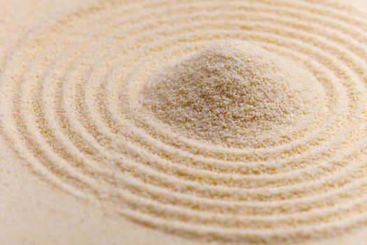 Abstract composition of fine yellow sand with circles