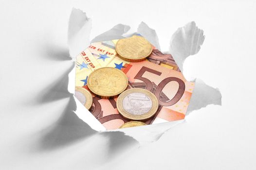 euro money behind hole in paper showing business and finance concept