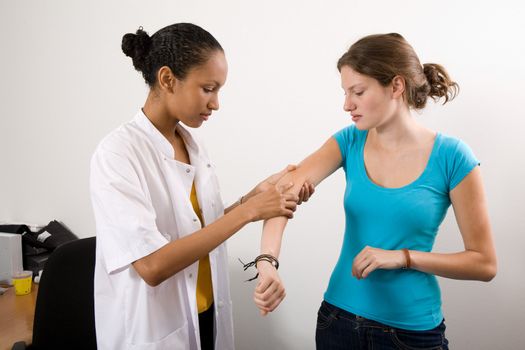 Doctor inspecting the arm of her patient