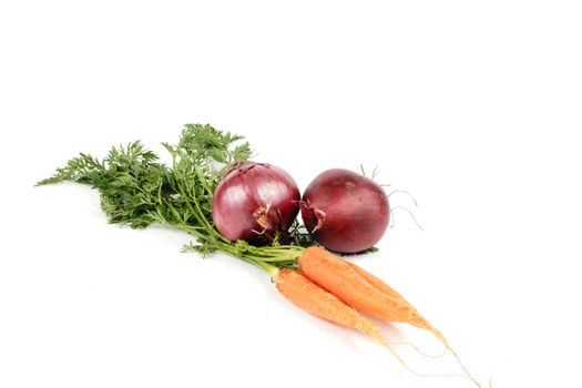 Bunch on raw crunchy carrots on a reflective white background