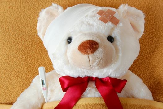 ill teddy bear in bed waiting for medicine