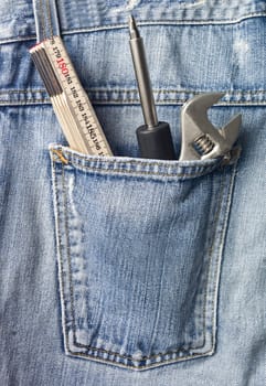 Tools in a back pocket of a pair of jeans