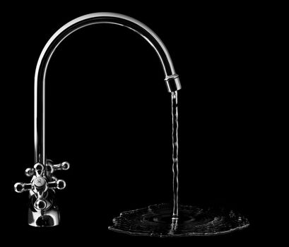 Water tap on black background