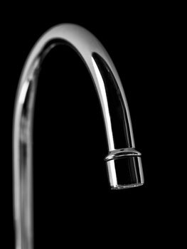 Water tap on black background
