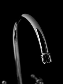 Water tap on black background