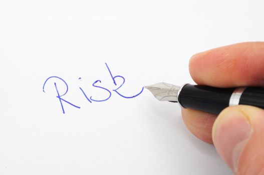 risk management concept with word on paper and pen