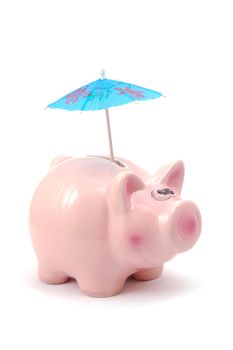 piggy bank and cocktail umbrella isolated on white background