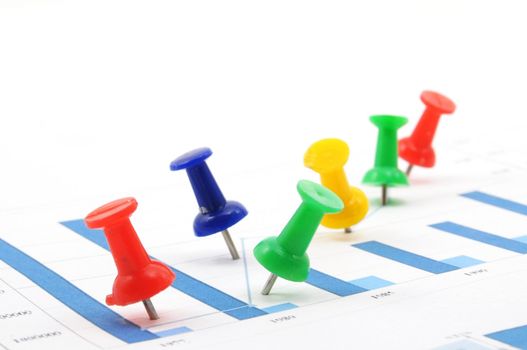 business growth chart with colorful pins on white background