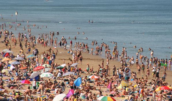 Crowded beach in summer in Scheveningen, Holland