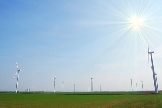 wind turbine under blue sky for alternative energy
