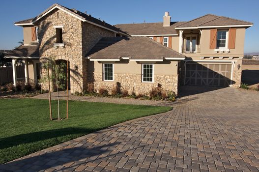 A newly constructed, modern american home with fresh landscaping.