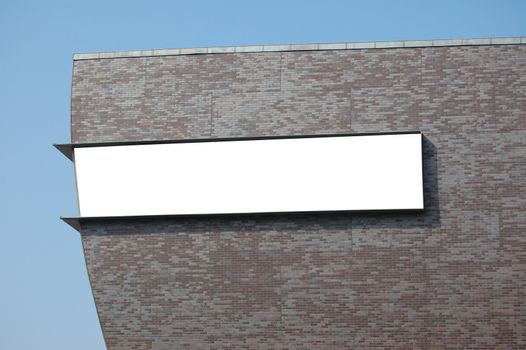 white empty billboard with copyspace for text and brickwall