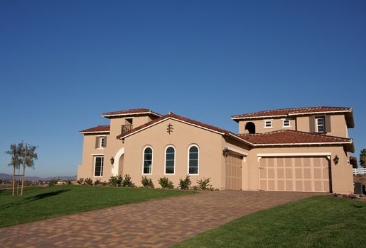 A newly constructed, modern american home with fresh landscaping.