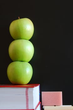 blank blackboard with apple and books and text space