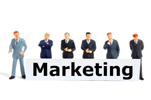 marketing concept with toy business man isolated on white background