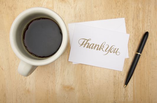 Thank You Note Card, Pen and Coffee Cup on Wood Background