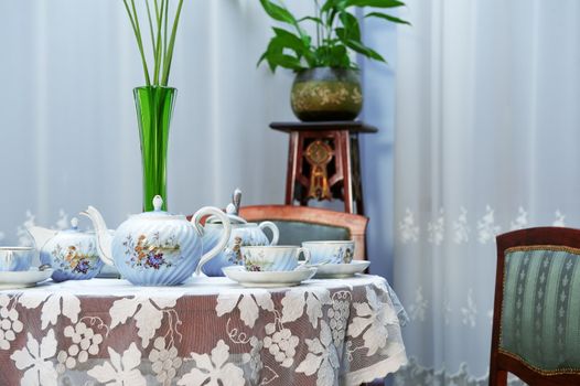 Table setting with tea service and vase